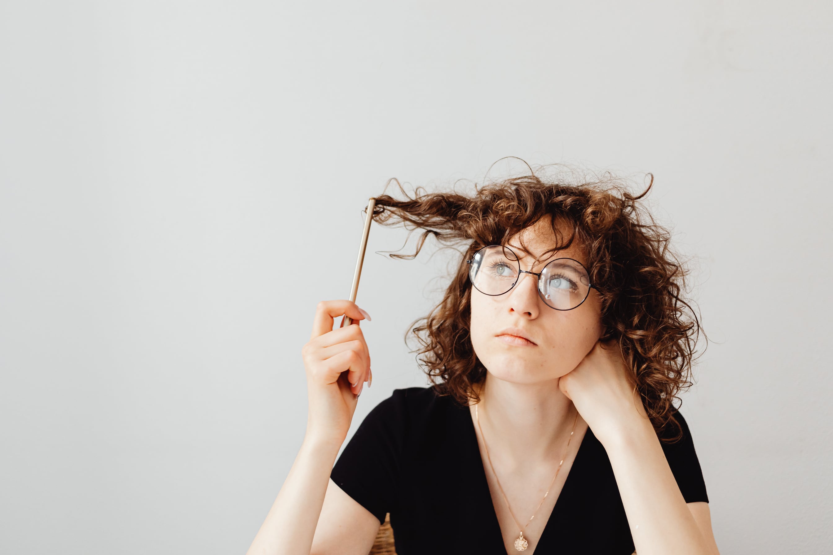 Woman in Black V-Neck Shirt Wearing Eyeglasses